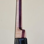 Black Compact Bass with Flame Maple and Purple Heart Neck.